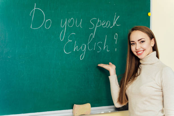 istock attractive teacher or student at the blackboard. 1165063857