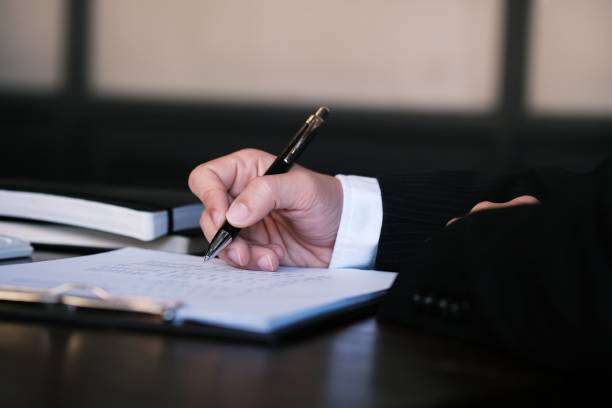 istock Businessman analyzing investment charts and pressing calculator buttons over documents. Accounting Concept. 1165066216