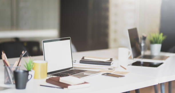 istock Open blank screen laptop and office supplies 1165067261