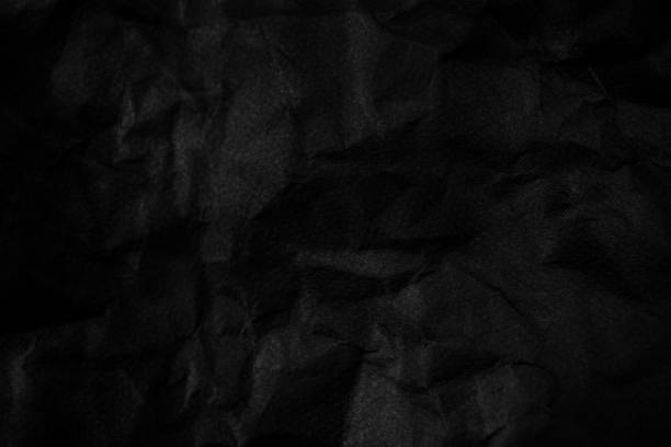 istock black wrinkled paper texture for you design background. 1165068996