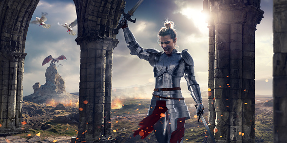 Fantasy image of a female medieval knight, wearing suit of armour with helmet removed, holding two swords, one held above head. The knight is walking past some stone pillars and arches as two doves fly past. Behind her is a fire scorched terrain with a dragon resting on a rock.