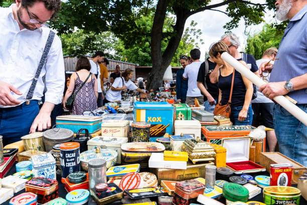 People searching the flea market for antiques and interesting buys at the Mauerpark. Mauerpark is a public park in the Prenzlauer Berg district. Flea market in Mauerpark is frequently used as sunday afternoon activity by hip Berliners and tourists. The flea market itself consists of mainly private salespersons who offer various items.