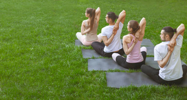 istock Friends making yoga exercises with hands hooked behind the back 1165070304