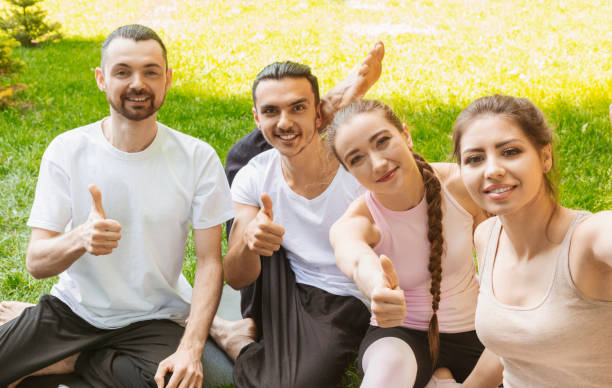 istock Smiling yoga students showing thumbs up after practicing. 1165071752