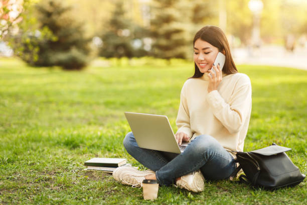 istock Girl relaxing in campus with gadgets, copy space 1165073197