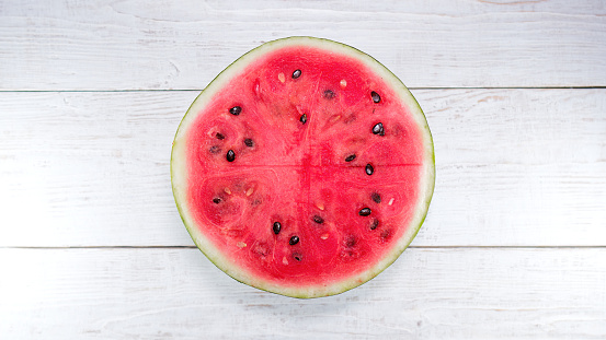 A half of fresh watermelon is on the table