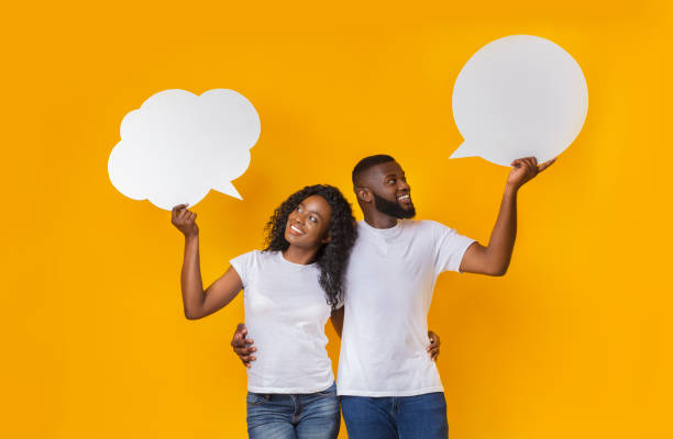 istock Young african american couple holding communication bubbles at studio 1165075266