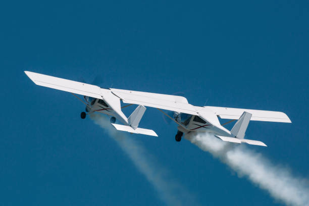 istock Aerobatic team perform a figure during airshow. Two airplane close flight 1165077198