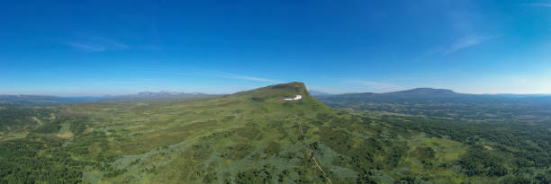 istock Mountain in the wilderness surrounded by a green lush landscape 1165078844