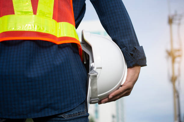 istock Engineering holds white safety hats and electric pole background 1165079653