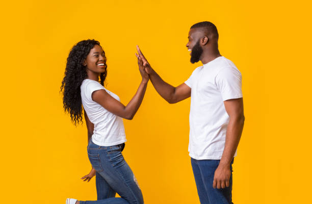 istock Happy man and woman greeting each other with high five 1165079699