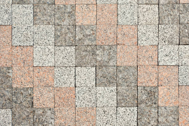 istock Cobblestone texture. The sidewalk tile is evenly folded. Various colors of granite and marble pavement. 1165080337