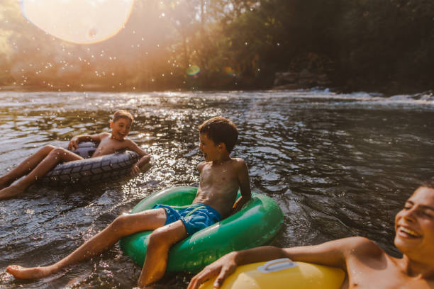 A perfect summer day Boys spending summer day on the river inflatable ring stock pictures, royalty-free photos & images