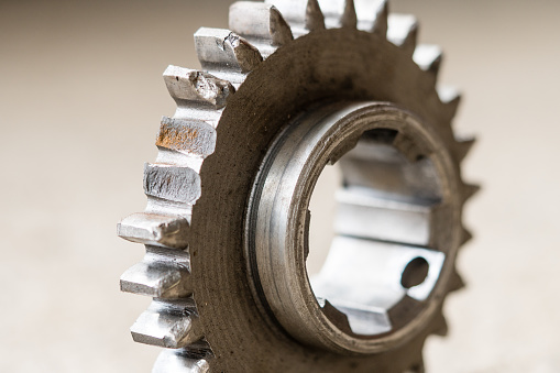 Closeup view on broken teeth on the gear. Mechanical workshop and repair concept.