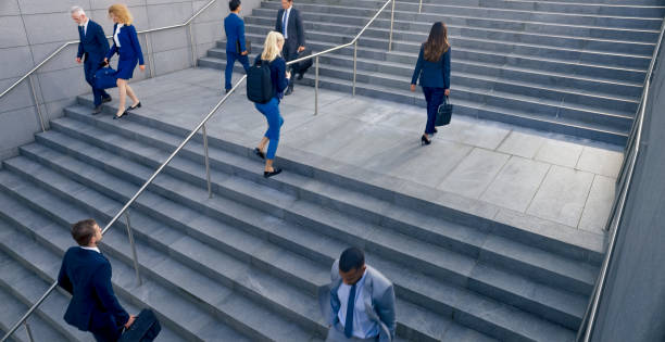 istock Business people walking on stairs 1165082343