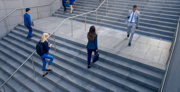 istock Business people walking on stairs 1165082346