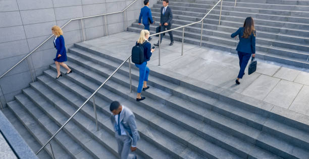 istock Business people walking on stairs 1165082362