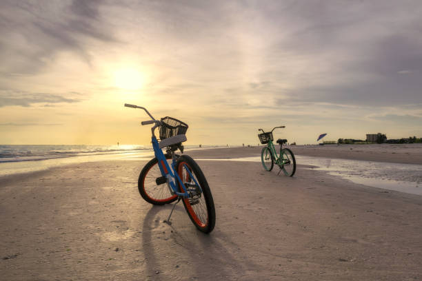 Bicycle on the beach Bicycle on the beach at Sunset in Siesta Key beach, Sarasota, Florida gulf of mexico stock pictures, royalty-free photos & images