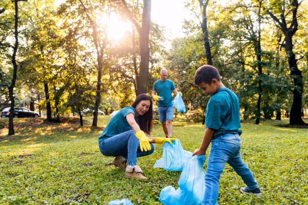 istock Multi-ethnic group of people recycling at park 1165086002