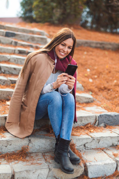istock Pretty woman using smart phone 1165094837