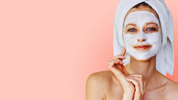 Beautiful Young Woman With Mask On Her Face Stock Photo - Download Image Now Facial Mask - Beauty Pink Color, Clay - iStock