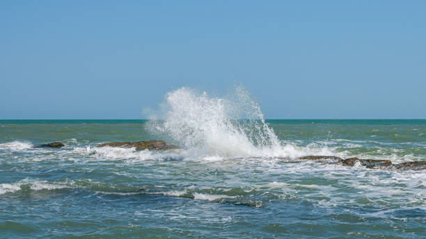 istock Waves breaking on coastal reefs, big splashes 1165097256