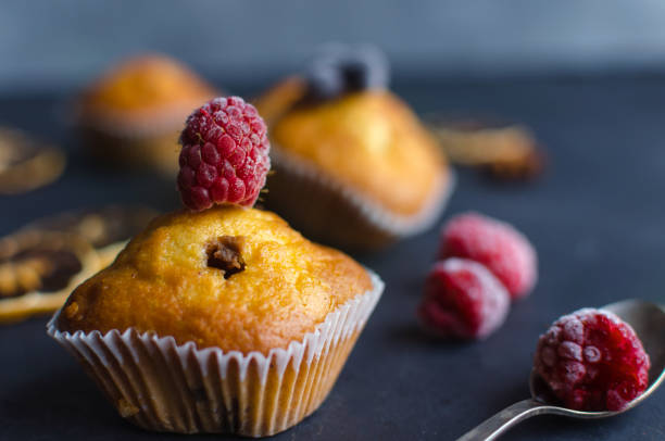 istock Sweet muffins with berries on dark textured background. 1165097357