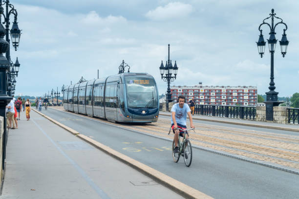 The Garonne River at Bordeaux, France with trams, cyclists and pedestrians on the Pont de Pierre bridge.