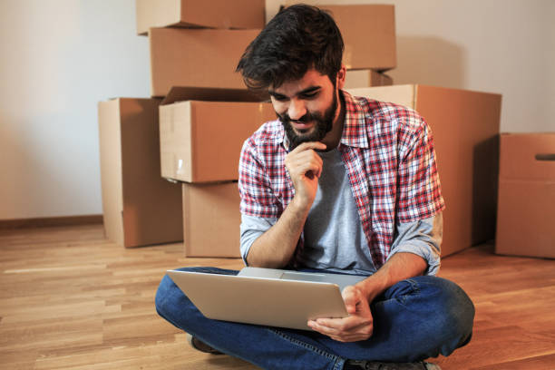 istock Young man moving into a new house. 1165098747