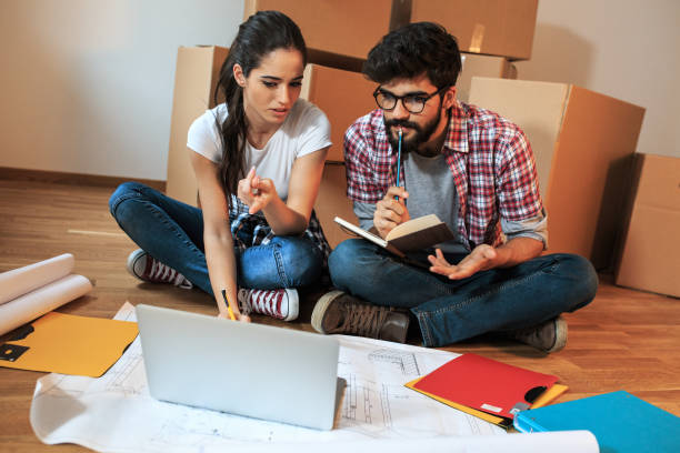 istock Young couple moving into a new house. 1165099091