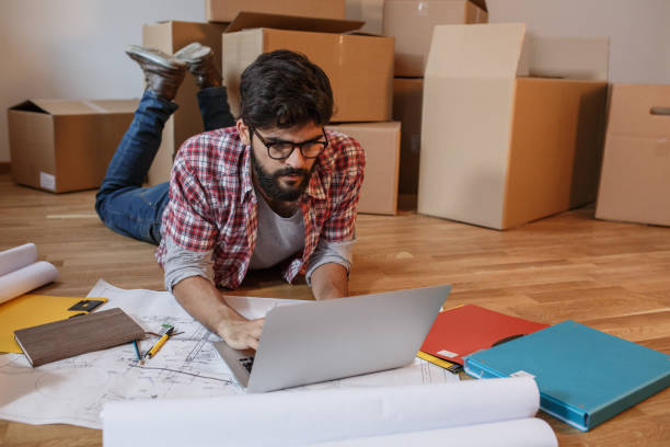 istock Young man moving into a new house. 1165099699