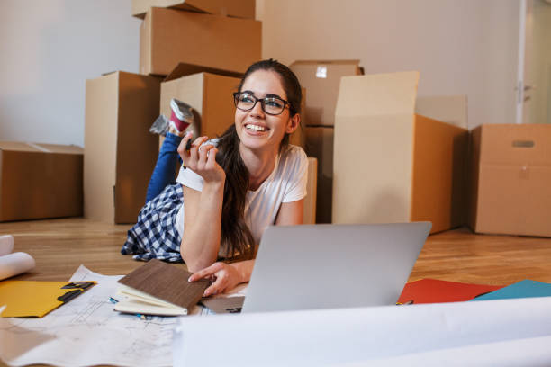 istock Young woman moving into a new house. 1165099877