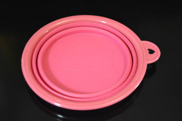 istock Pink folding and multifunctional rubber plate, a bowl with a plastic edging on a black glossy surface. 1165101946