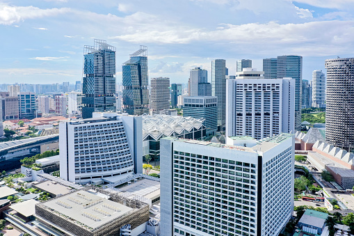 Singapore city business district and its skyscrapers and roads seen a hot summer day.