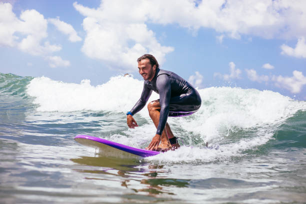 istock Attractive man surfing a wave off the coast 1165104625