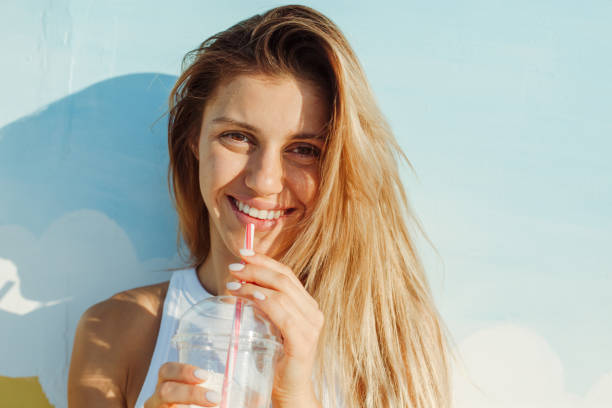 istock Cheerful young women in swimwear drinking 1165105646