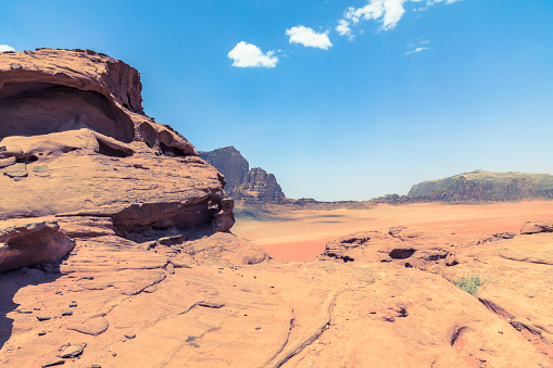 Red sand desert at sunny summer day in Wadi Rum, Jordan. Middle East. UNESCO World Heritage Site and is known as The Valley of the Moon.