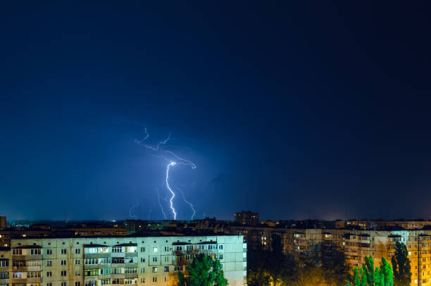 istock Thunderstorm with lightning and thunder over the night city 1165110461