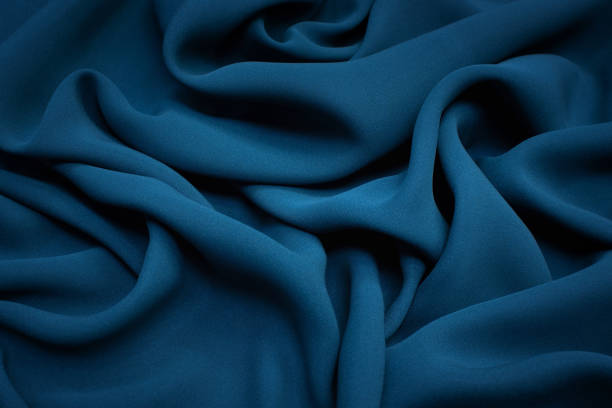 la textura de la tela de seda es el color de la onda de mar oscura. fondo, patrón. - rayon fotografías e imágenes de stock