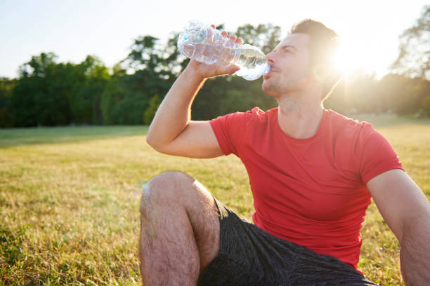 istock Drinking water and resting after workout on the fresh air 1165112751