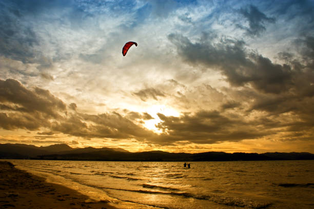 Kitesurfing at sunset time on the river in Laredo, Spain.