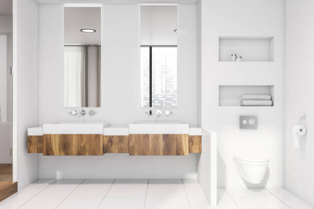 istock White bathroom with double sink and toilet 1165113961
