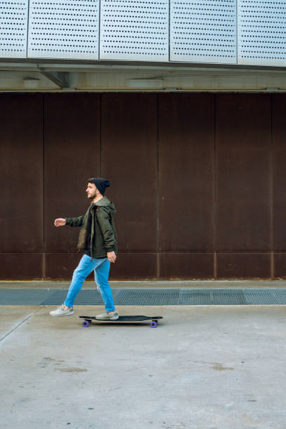 istock Man having fun with a longboard in Barcelona 1165114572