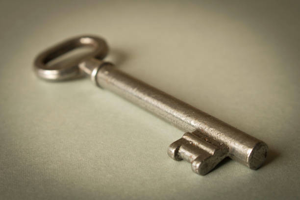 istock Old key on grey background. Key isolated on grey background. 1165115374