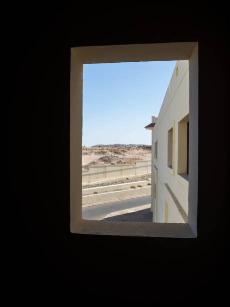 istock desert view from window, sandy mountains and house 1165115971