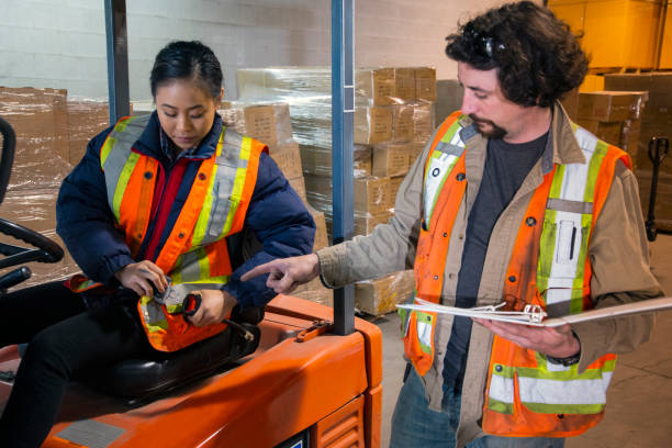 istock An industrial warehouse workplace safety topic.  A safety supervisor or manager training a new employee on forklift safety. 1165119166