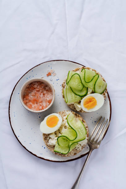 istock Sandwich with boiled egg and cucumber on ceramic plate on gray old background. Top view. 1165119957