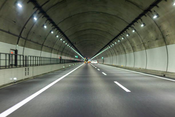 istock view of highway tunnel in mountains. 1165124019