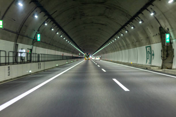 istock view of highway tunnel in mountains. 1165124021