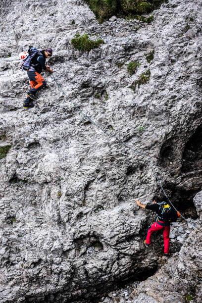 istock Alpinists ascend along a mountain gully 1165125391
